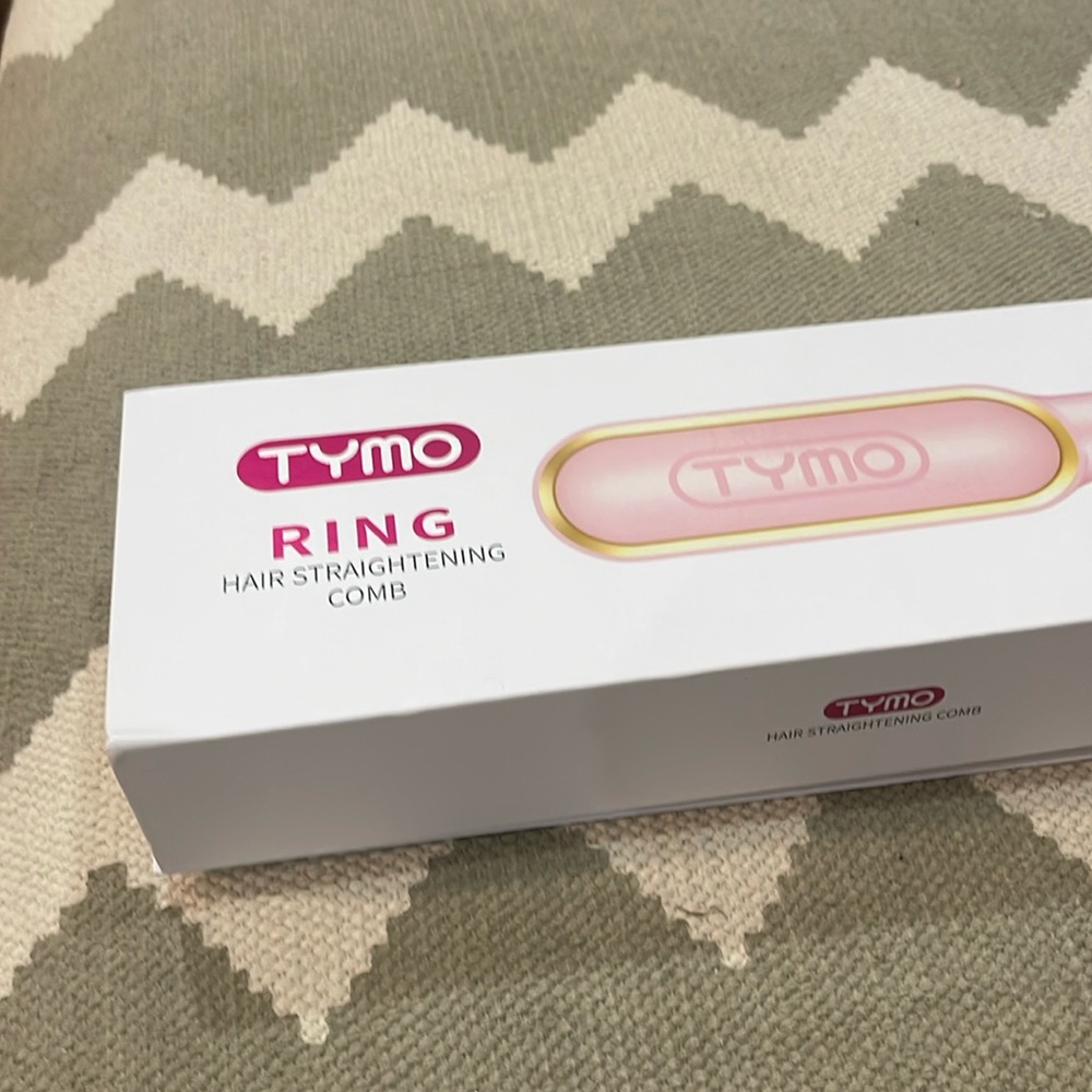 Brand new.  Pink Tymo Ring still in box!  Hair straightening tool.